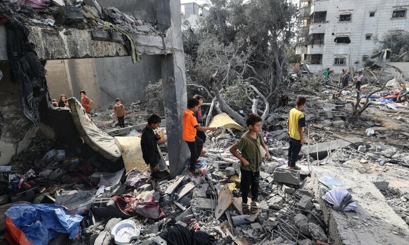 Palestinian children check the rubble of a residential house in Deir el-Balah in the central Gaza Strip on July 1. &mdash; AFP