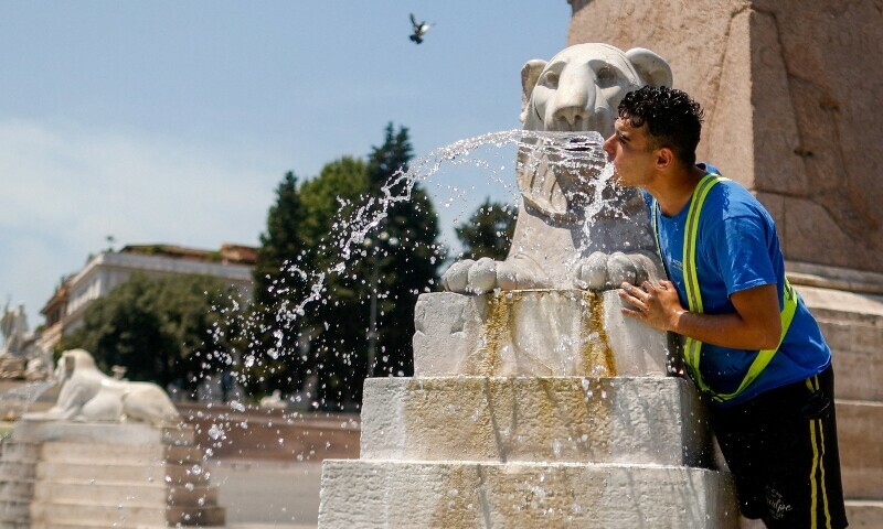 A man cools off with water at Piazza del Popolo during a heatwave in Rome, Italy, July 2. — Reuters