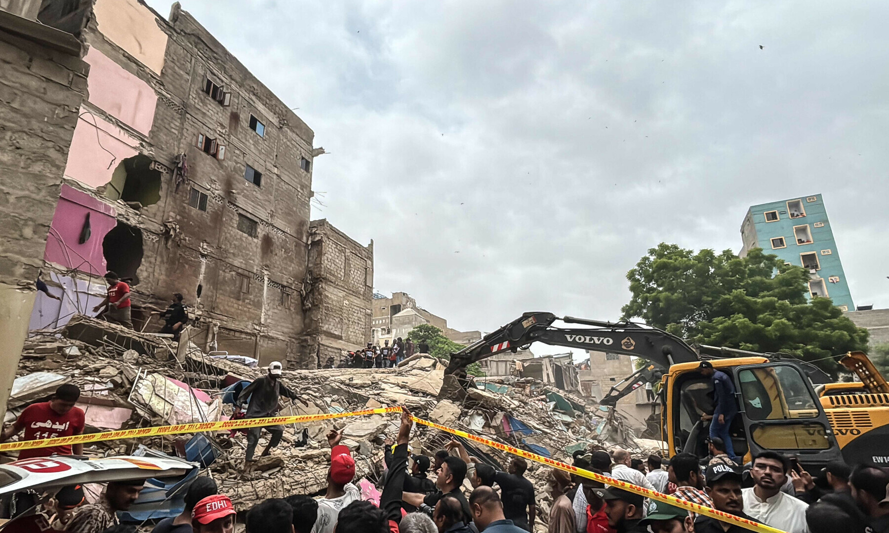 Rescuers search for victims in the rubble of a collapsed five-storey residential building in Karachi on July 4, 2025. — AFP