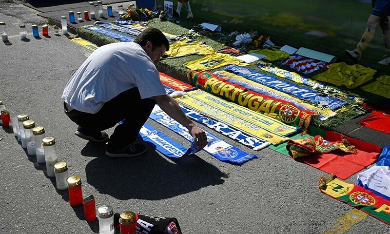 A well-wisher leaves a scarf at a memorial for Liverpool’s Portuguese forward Diogo Jota, set up at the Gondomar Sport Clube stadium, where the late footballer began his career, in Gondomar, on the outskirts of Porto, on July 4, 2025. — AFP