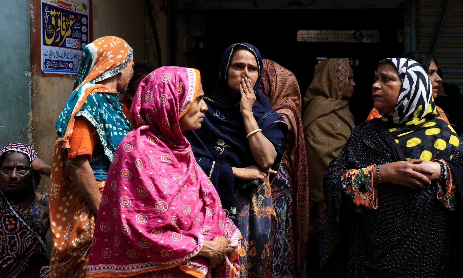  Women residents stand by, as rescue workers search for survivors in the rubble of a five-storey residential building, which collapsed in Karachi on July 4, 2025. — Reuters/Akhtar Soomro 