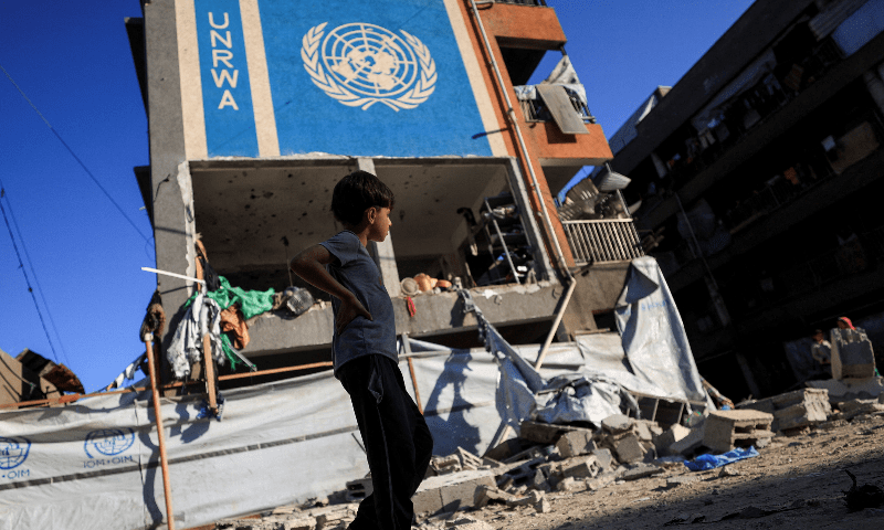 A Palestinian boy walks near an UNRWA school sheltering displaced people that was hit in an an overnight Israeli strike, in Gaza City on July 5, 2025. — Reuters
