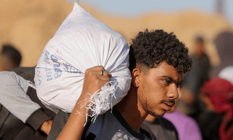 A Palestinian carries a sack with aid supplies he received from the US-backed Gaza Humanitarian Foundation, in Khan Younis, in the southern Gaza Strip on May 29, 2025. — Reuters