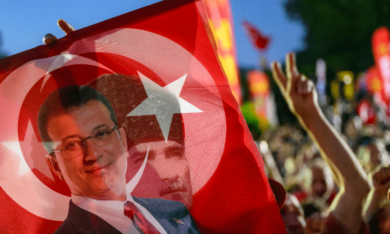 A supporter holds a flag of Istanbul’s detained Mayor Ekrem Imamoglu and the First President of the Republic of Turkiye Mustafa Kemal Ataturk as they listen to the leader of Turkey’s main opposition Republican People’s Party (CHP) Ozgur Ozel (not pictured) during a rally protesting the 100th day of the detention of Istanbul’s Mayor, in Sarachane Square, Istanbul on July 1, 2025. — AFP