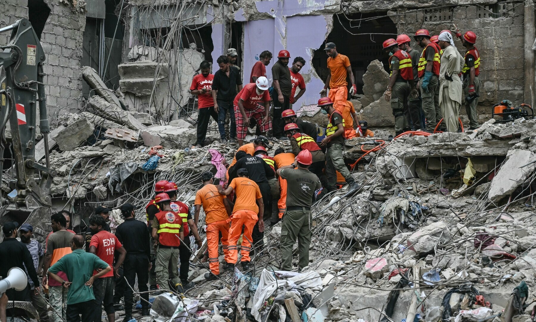 Rescue workers conduct a search operation amid the debris of a collapsed residential building in Karachi on July 5, 2025. — AFP