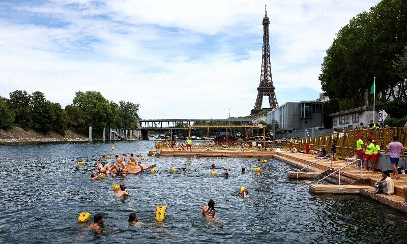 People swim in the River Seine, with the Eiffel tower in the background, at the Grenelle site, in Paris, France, July 5. — Reuters