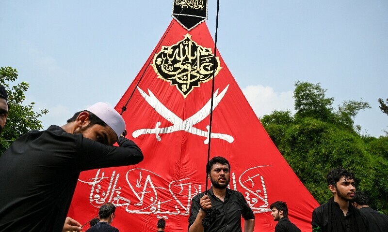 Shia mourners take part in a mourning ritual procession on the ninth day of Muharram in Islamabad on July 5. — AFP