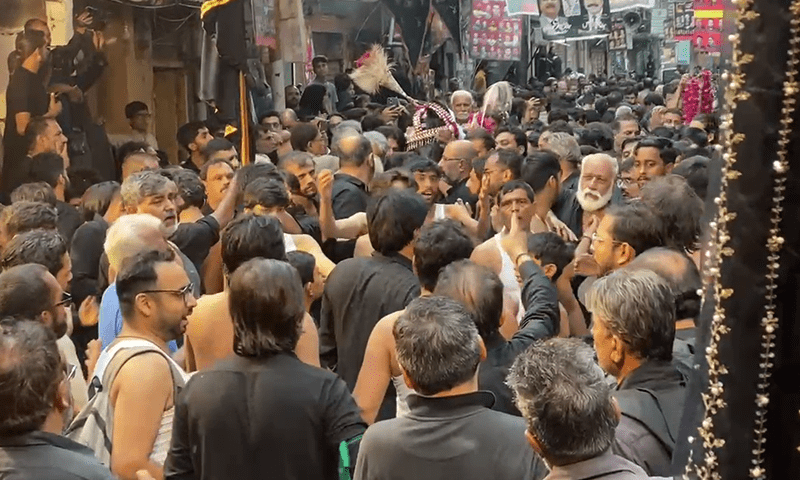 Mourners participate in a Muharram 10 procession in Lahore on July 6. — DawnNews TV
