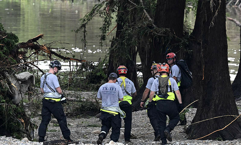 Members of a search and rescue team look for people near Camp Mystic, the site of where at least 20 girls went missing after flash flooding in Hunt, Texas, the US on July 5. — AFP