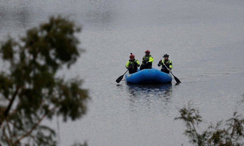 Rescuers paddle an inflatable boat as they search along a waterway following flash flooding, in Kerrville, Texas, US on July 6. &mdash; Reuters