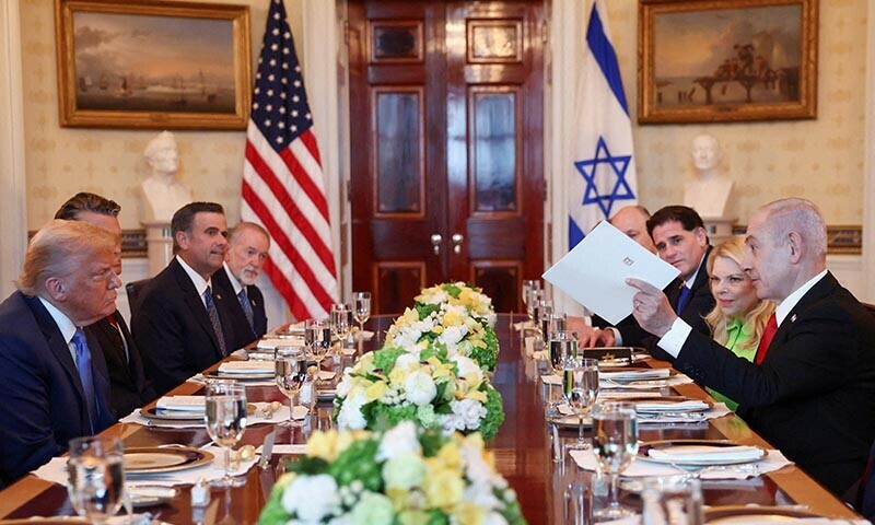 Israeli Prime Minister Benjamin Netanyahu hands over a nomination letter as he tells US President Donald Trump he has nominated him for the Nobel Peace Prize, during a bilateral dinner, at the White House in Washington, DS, US on July 7, 2025. — Reuters