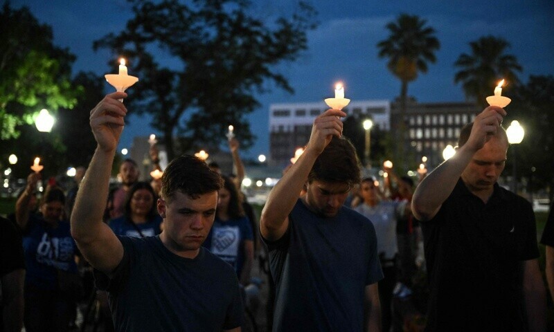 People hold up candles as they take part in a vigil for the victims of the floods over Fourth of July weekend, at Travis Park, in San Antonio, Texas, on July 7, 2025. The death toll from catastrophic flooding in Texas rose to more than 100 on July 7, 2025. — AFP