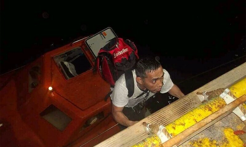 This handout picture provided by the UAE Ministry of Foreign Affairs reportedly shows members of the Greek owned, Liberian-flagged Magic Seas commercial vessel climbing on board the Safeen Prism after being rescued following an attack that forced them to abandon ship, in the Red Sea on July 6. — AFP