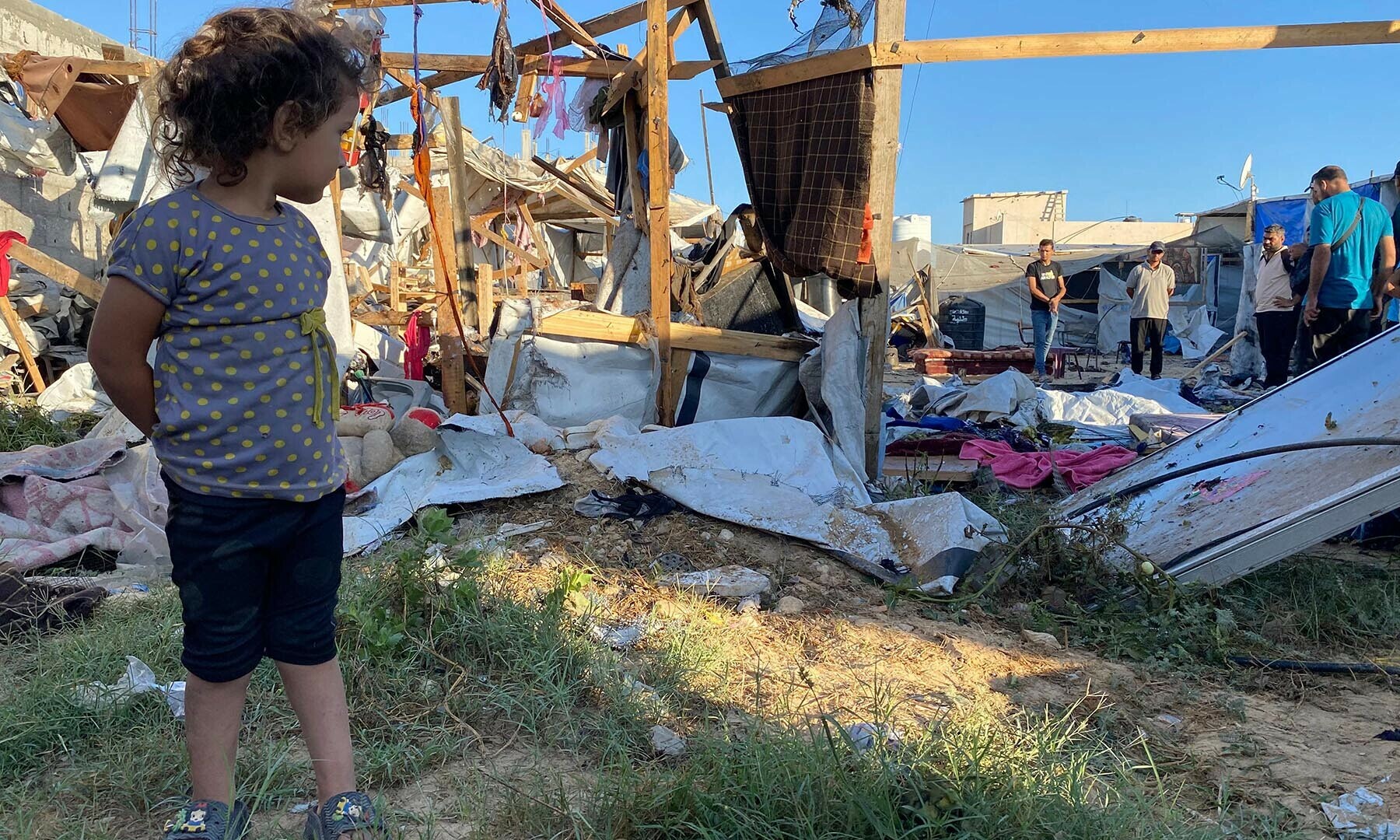 A Palestinian girl inspects the damage after an Israeli strike at a camp for displaced people near Khan Yunis in the southern Gaza Strip city on July 9, 2025. (Photo by AFP)