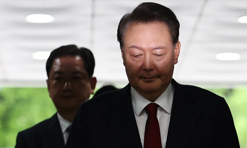 South Korea&rsquo;s former impeached president Yoon Suk Yeol (R) arrives at a court to attend a hearing to review his arrest warrant requested by special prosecutors in Seoul on July 9. &mdash; AFP