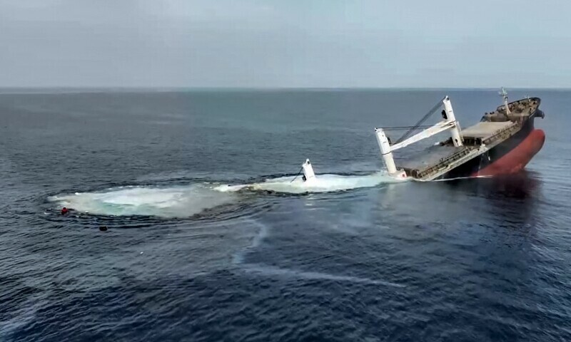 This handout picture released by Yemen’s Huthi Ansarullah Media Centre on July 8, 2025 reportedly shows the Liberia-flagged bulk carrier Eternity sinking C after it was attacked by the Huthis at sea.— AFP
