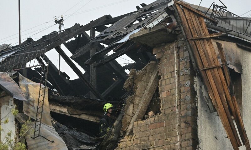 A Ukrainian firefighter works at a damaged residential building after a Russian missile and drone attack in Kyiv on July 10. — AFP