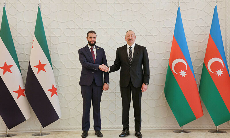 This handout picture released by the Syrian Presidency shows Azerbaijan’s President Ilham Aliyev (R) receiving Syria’s interim President, Ahmed al-Sharaa, in Baku, Azerbaijan, July 12. — AFP
