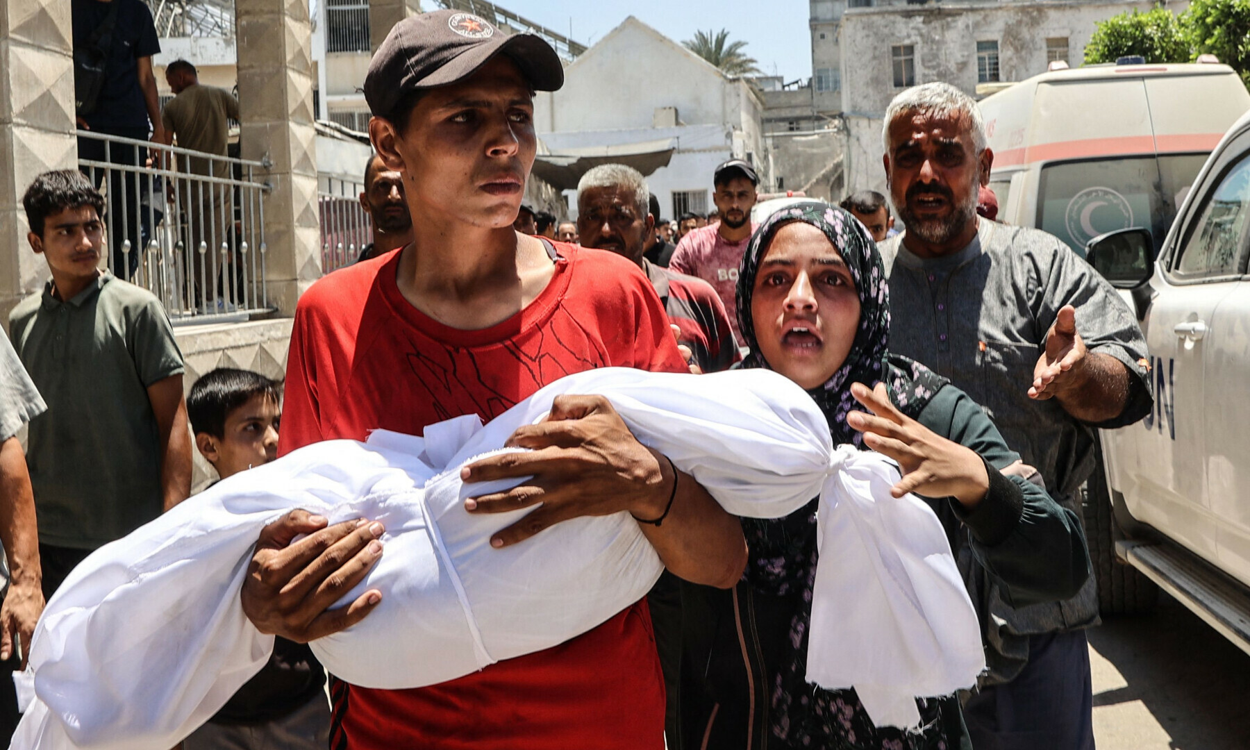 A Palestinian woman reacts as a young man carries the body of her child killed in an Israeli strike, in front of Gaza City’s Baptist hospital on July 13, 2025. — AFP