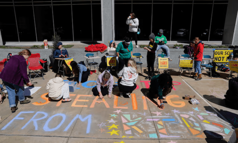 Demonstrators write messages during a Defend Our Schools rally to protest US President Donald Trump’s executive order to shut down the US Department of Education outside its building in Washington, DC, US on March 21, 2025. — Reuters/File