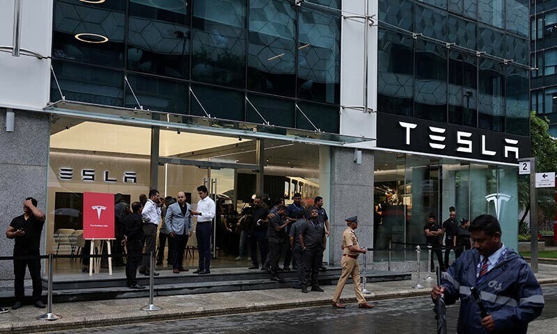  People are seen outside the Tesla showroom ahead of its opening in Mumbai, India on July 15, 2025. — Reuters 