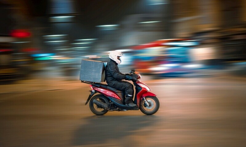 Image showing a delivery rider on a motorcycle. Photo for representation only. — Unsplash/ Rowan Freeman