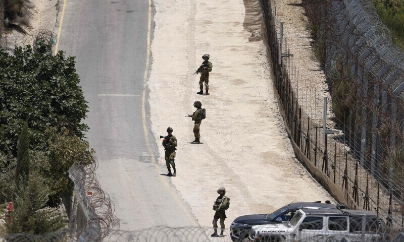 Isaeli troops stand guard on the dividing line between the Israeli-annexed Golan Heights and the Syrian side, near Majdal Shams, July 16. — AFP
