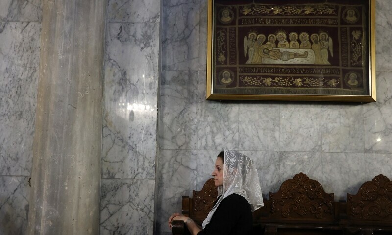 A Christian Palestinian woman attends the funeral ceremony of Saad Salameh and Foumia Ayyad, killed earlier in an Israeli strike that hit the Holy Family Church in Gaza City, at the Saint Porphyrius Church on July 17. &mdash; AFP