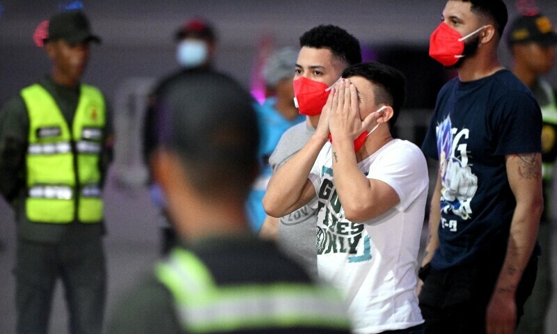 A Venezuelan migrant who was jailed in El Salvador reacts after getting off a plane at Simon Bolivar International Airport in Maiquetia, Venezuela on July 18. — AFP