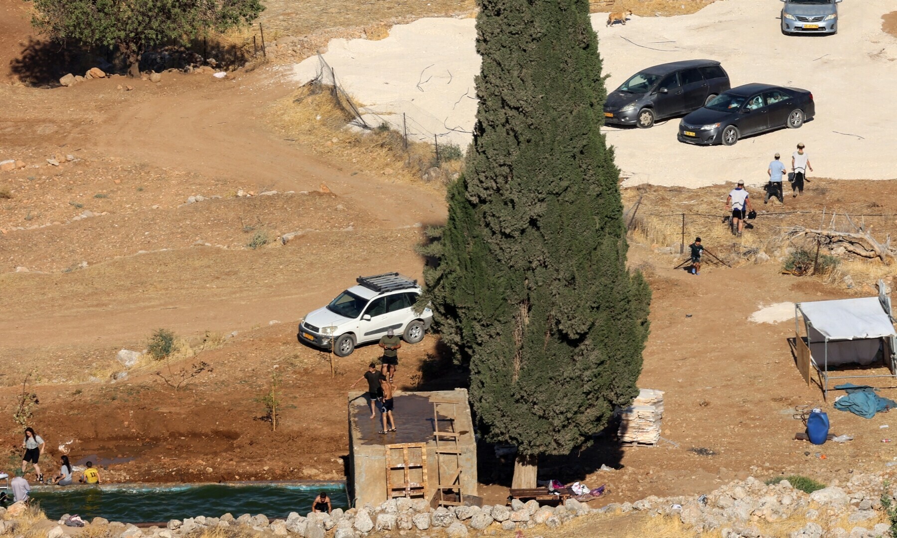Israeli settlers swim in the Ein Samiyah spring near the village of Kafr Malik, in the Israel-occupied West Bank, on July 15, 2025. — AFP