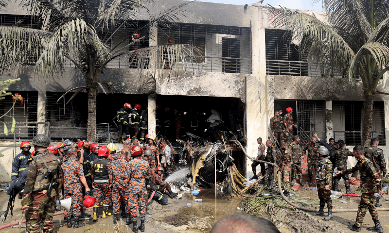 Firefighters and soldiers work next to the wreckage of an air force training aircraft after it crashed into Milestone College campus, in Dhaka, Bangladesh on July 21, 2025. &mdash; Reuters