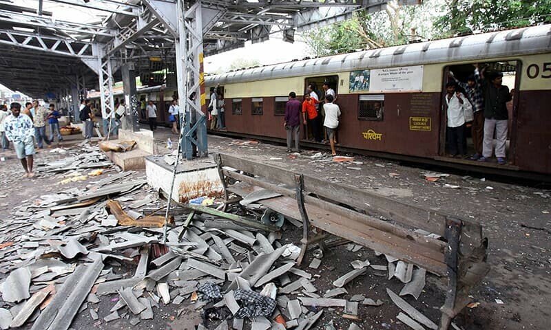 In this photograph taken on July 12, 2006, Indian commuters walk past the blast site at Mahim railway station in Mumbai, the day after a wave of coordinated blasts on commuter trains in India’s financial capital. — AFP/File In this photograph taken on July 12, 2006, Indian commuters walk past the blast site at Mahim railway station in Mumbai, the day after a wave of coordinated blasts on commuter trains in India’s financial capital. — AFP/File