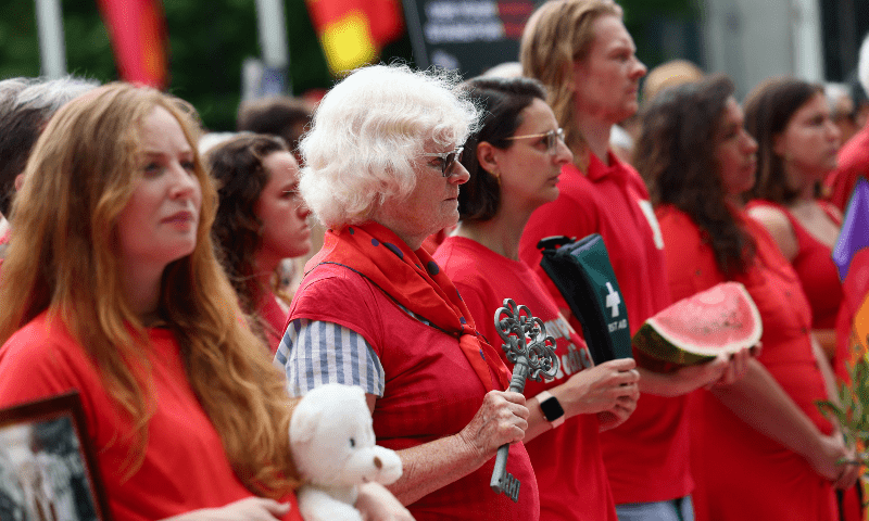 Members of the public gather in Parliament Square wearing red and holding items behind a giant &lsquo;Red Line for Gaza&rsquo; banner to symbolise what is being lost due to the conflict, in London, Britain, on July 22. &mdash; Reuters