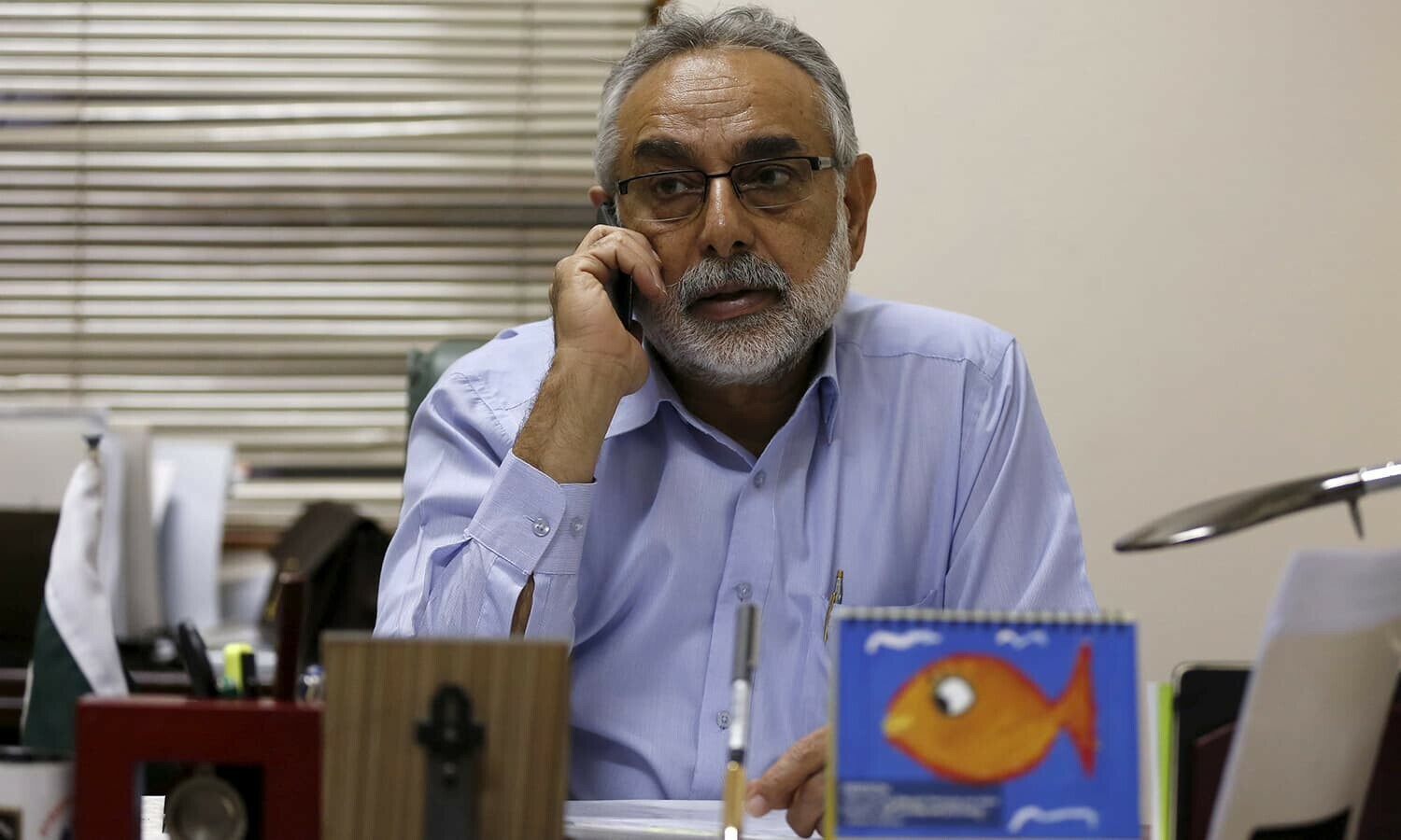 Chief of Citizen Police Liaison Committee (CPLC) Zubair Habib, talks on a mobile phone at his office in Karachi, Pakistan February 9, 2016.  — Reuters/File