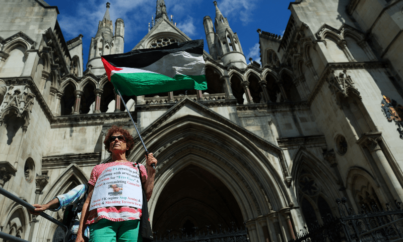 A person holds a Palestinian flag outside the High Court on the day of a hearing about the banned pro-Palestinian campaign organisation Palestine Action, in London, Britain on July 21, 2025. — Reuters