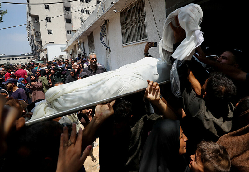 Mourners gather at the funeral of Palestinians killed in an Israeli strike on a school sheltering displaced people, according to the medics, at Al-Shifa Hospital in Gaza City, July 25. &mdash; Reuters
