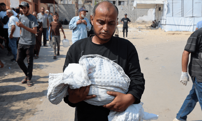 Ahmed Abu Haleeb, the father of Palestinian baby Zainab Abu Haleeb, who died due to malnutrition according to health officials, holds her body in Khan Younis, southern Gaza Strip on July 26, 2025. &mdash; Reuters