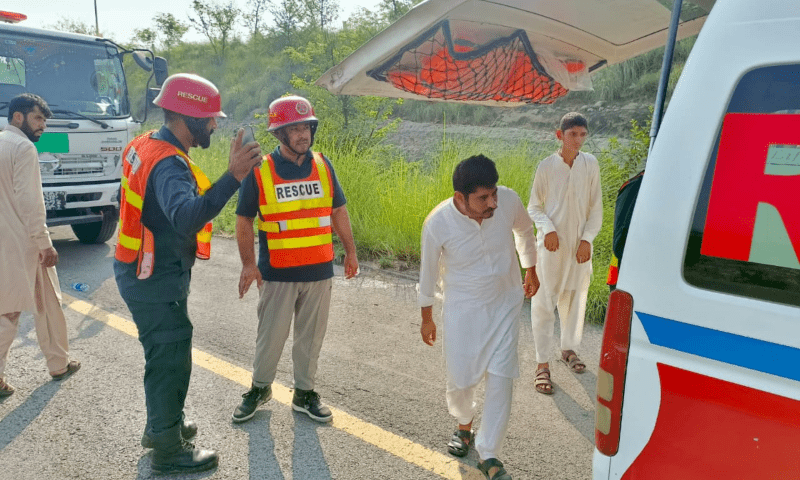  Rescue personnel on the site after a bus heading to Lahore from Islamabad overturned near the Balkassar Interchange on July 27, 2025. — Rescue 1122 