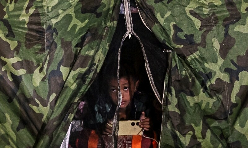 A boy displaced by the ongoing conflict between Thailand and Cambodia rests at an evacuation centre in the Thai border province of Si Sa Ket on July 26. — AFP A boy displaced by the ongoing conflict between Thailand and Cambodia rests at an evacuation centre in the Thai border province of Si Sa Ket on July 26. — AFP