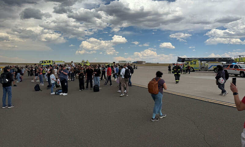 Passengers gather after evacuating an American Airlines plane that caught fire, at the Denver International Airport, Denver, Colorado, US, July 26, 2025,  &mdash;@highlymigratoryfishing /Instagram via Reuters