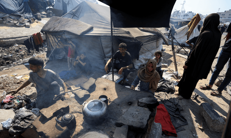 Displaced Palestinians who have not received humanitarian aid gather as they survive on leftover food, amid a hunger crisis in Gaza on July 28, 2025. &mdash; Reuters