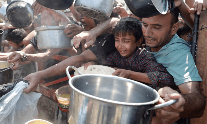  Palestinians gather to receive food from a charity kitchen, amid a hunger crisis, in Gaza City on July 28, 2025. &mdash; Reuters 