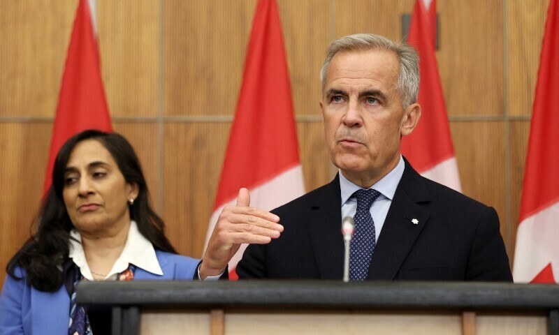 Canadian Prime Minister Mark Carney (R), flanked by Canadian Foreign Affairs Minister Anita Anand, speaks during a press conference after a Cabinet meeting in Ottawa, Ontario, Canada on July 30. — AFP