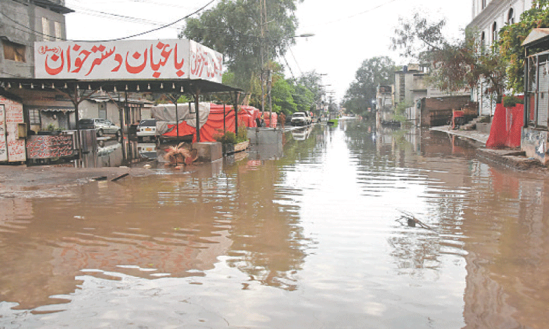 Heavy rain inundates a road of Mukha Singh Estate in Rawalpindi on Tuesday. &mdash; Online