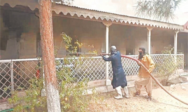 MASTUNG: Firefighters attempt to extinguish a fire in the tehsil office after armed attackers set government buildings ablaze.—Photo by Khair Muhammad