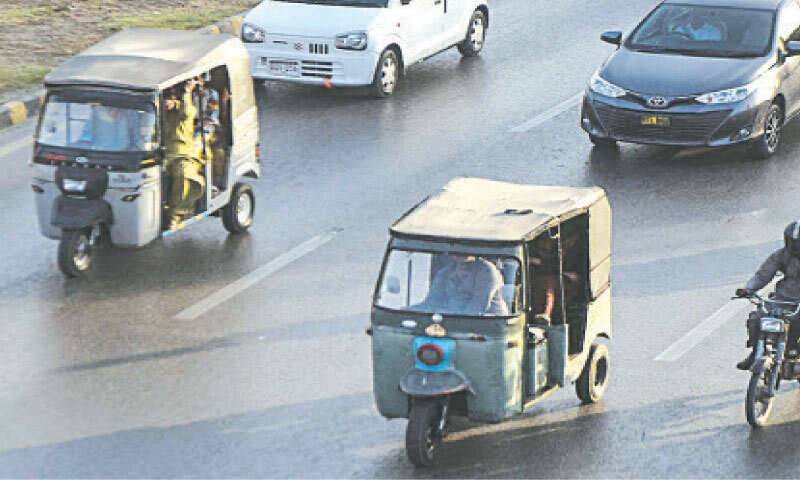 A couple of rickshaw owners venture onto Sharea Faisal despite the ban.&mdash;Fahim Siddiqi / White Star
