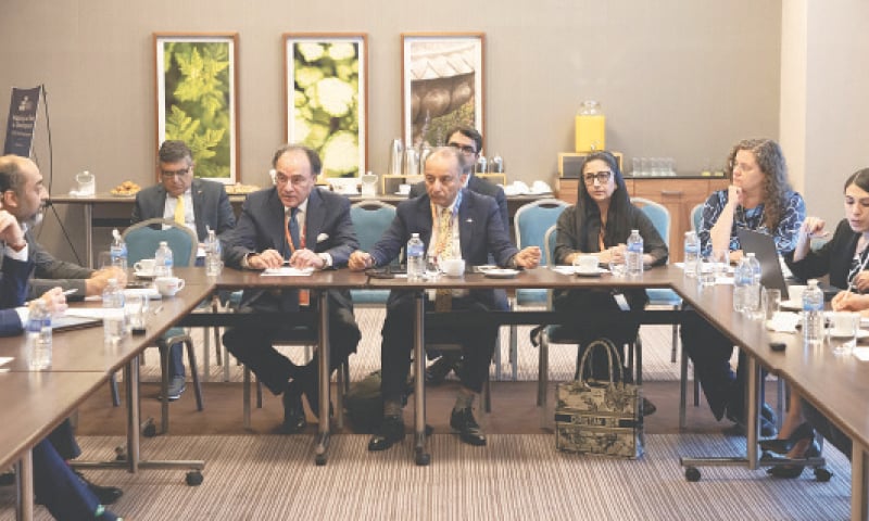 FLANKED by Musadik Malik and Shezra Mansab, Finance Minister M. Aurangzeb addresses a roundtable in Seville, Spain.—Courtesy Tabadlab