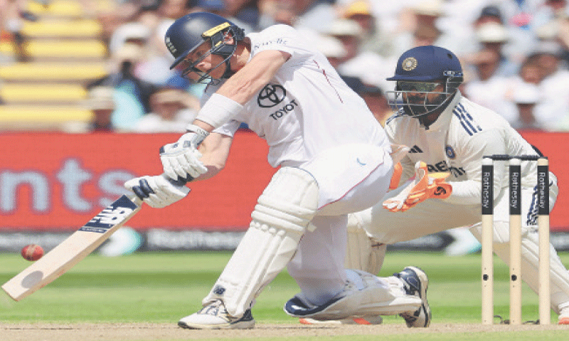 ENGLAND batter Jamie Smith plays a shot as India wicket-keeper Rishabh Pant looks on during the second Test at Edgbaston on Friday.—AFP