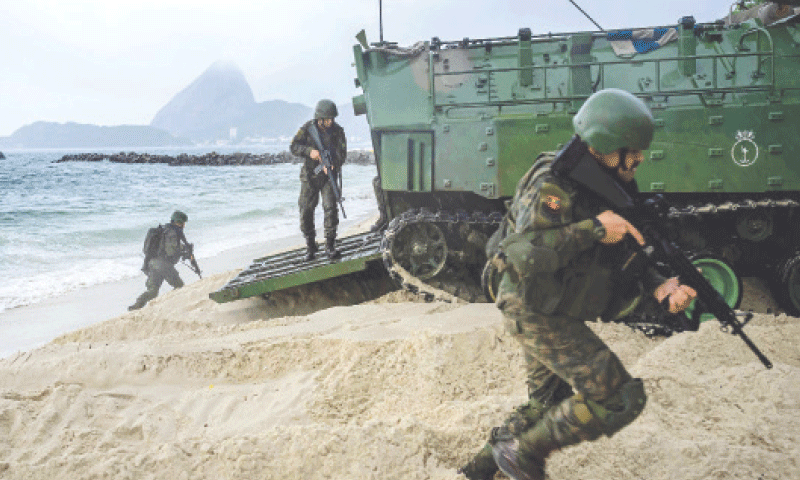 MEMBERS of Brazil’s navy participate in an exercise at Rio de Janeiro’s Prainha da Gloria beach, near the Modern Art Museum where the BRICS summit will be held on Sunday and Monday.—AFP