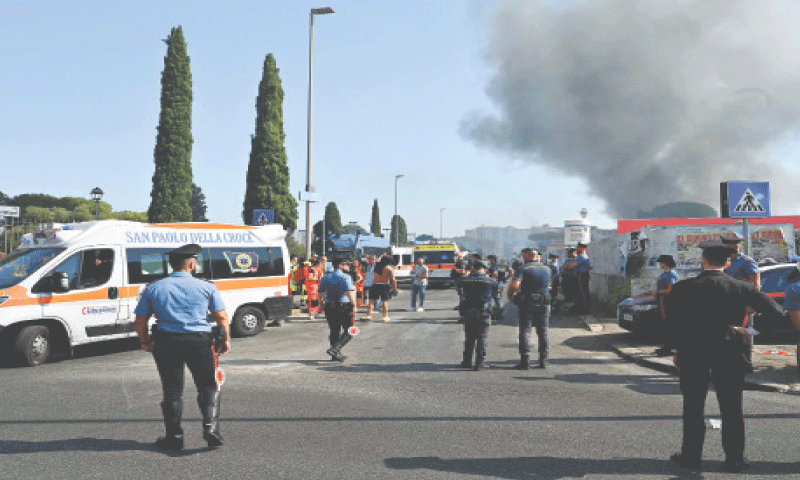 FIREMEN, policemen and rescue teams work on the site of the explosion at a fuel station in Rome.­—AFP